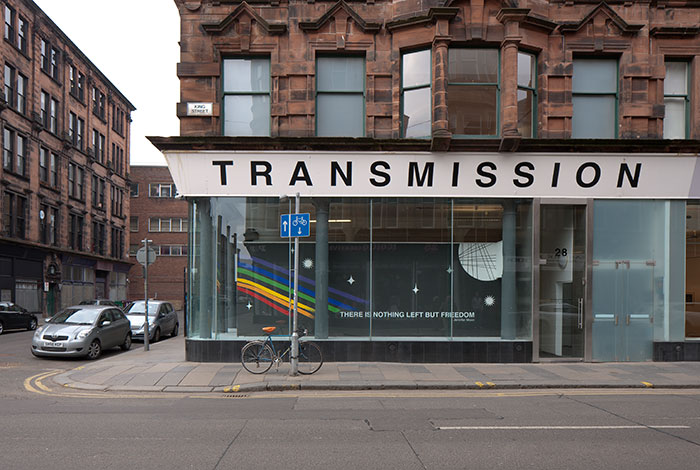 documentation photo of one wall of a window mural with text that reads, There is Nothing left but Freedom, Jennifer Moon